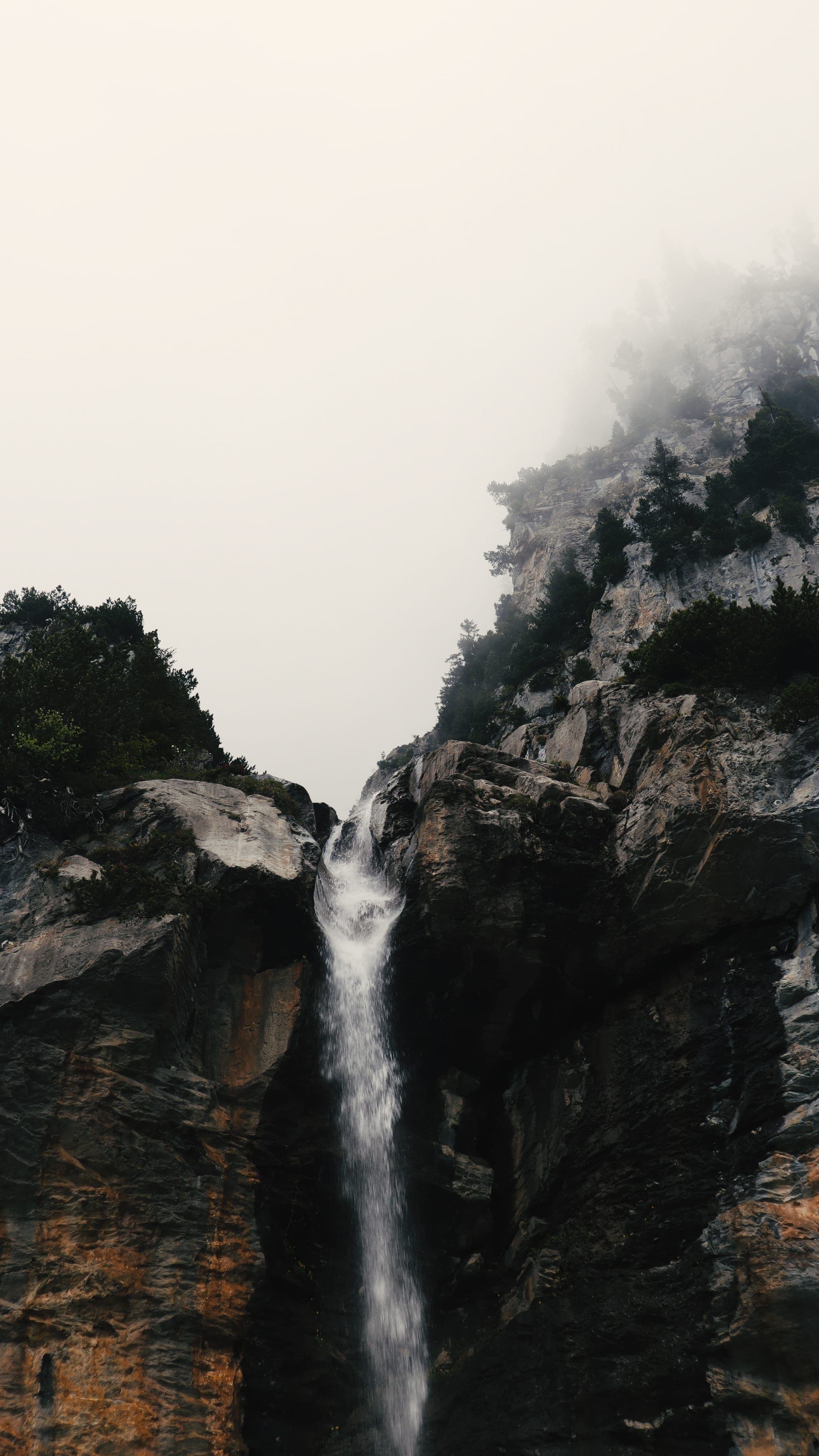 Waterfall cascading into alpine lake